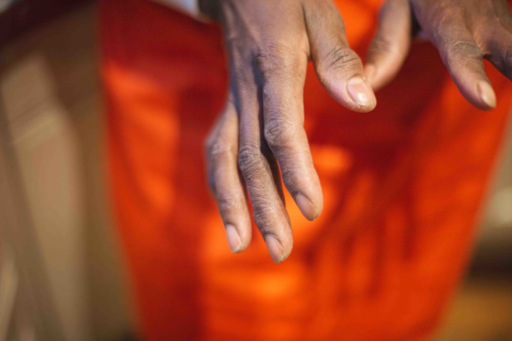 Gros plan sur les mains de Mariam, usées par les produits